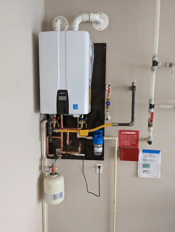 Professional plumber installing copper piping in a Anderson home